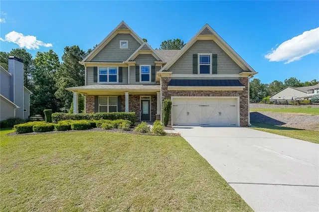 a front view of a house with a yard and garage