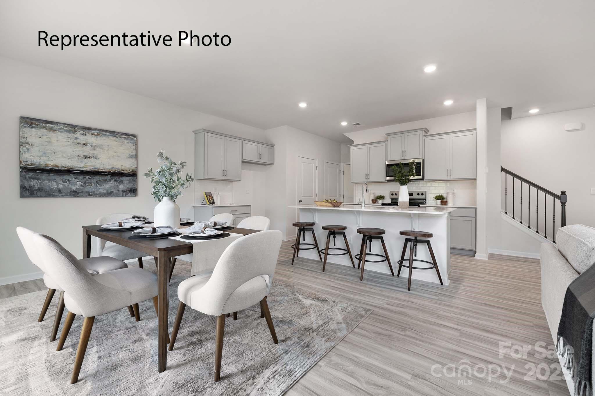 3102 Ora Smith Road Lincolnton, NC 28092 - Photo 15 of 28 a kitchen with stainless steel appliances kitchen island granite countertop a stove a sink a table and chairs