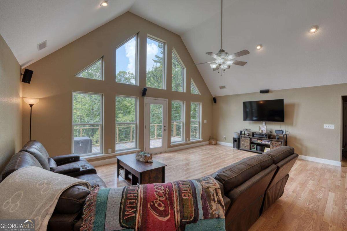 4165 Mobile Road, Unit 4 McCaysville, GA 30555 - Photo 15 of 52 a living room with furniture a flat screen tv and a large window