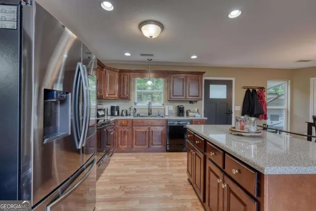 a view of a dining room with furniture and chandelier