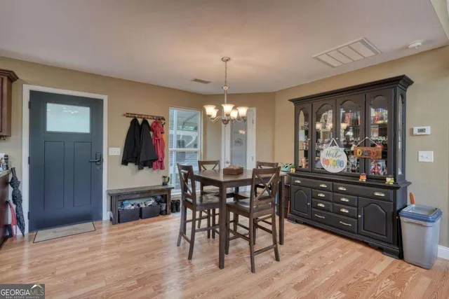 a large kitchen with a table and chairs