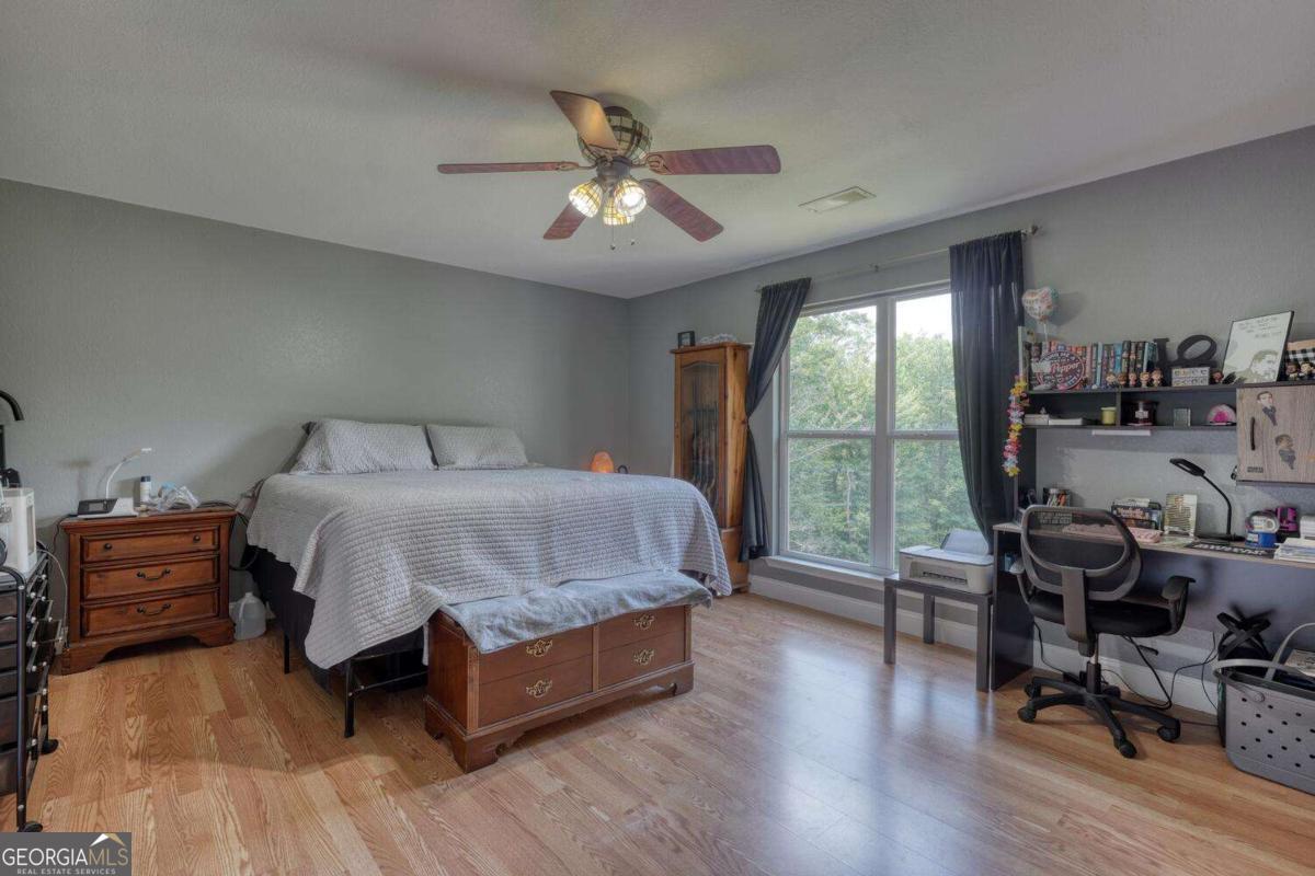 4165 Mobile Road, Unit 4 McCaysville, GA 30555 - Photo 24 of 52 a bedroom with a bed and wooden floor