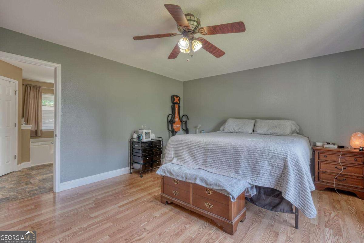 4165 Mobile Road, Unit 4 McCaysville, GA 30555 - Photo 25 of 52 a bedroom with a bed and a chandelier