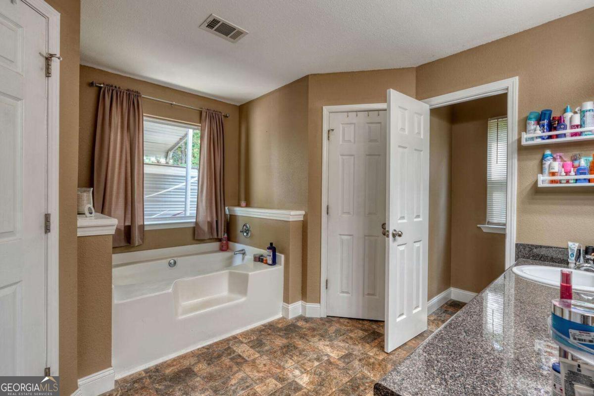 4165 Mobile Road, Unit 4 McCaysville, GA 30555 - Photo 27 of 52 a spacious bathroom with a tub shower and sink