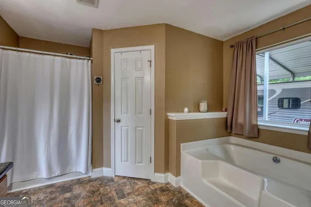 a bedroom with furniture and a window