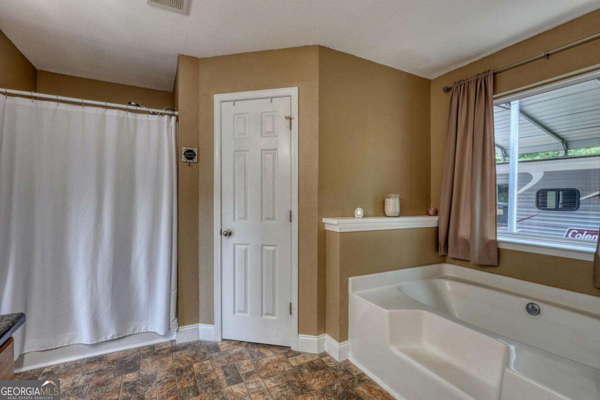 4165 Mobile Road, Unit 4 McCaysville, GA 30555 - Photo 29 of 52 a bathroom with a sink a toilet and shower