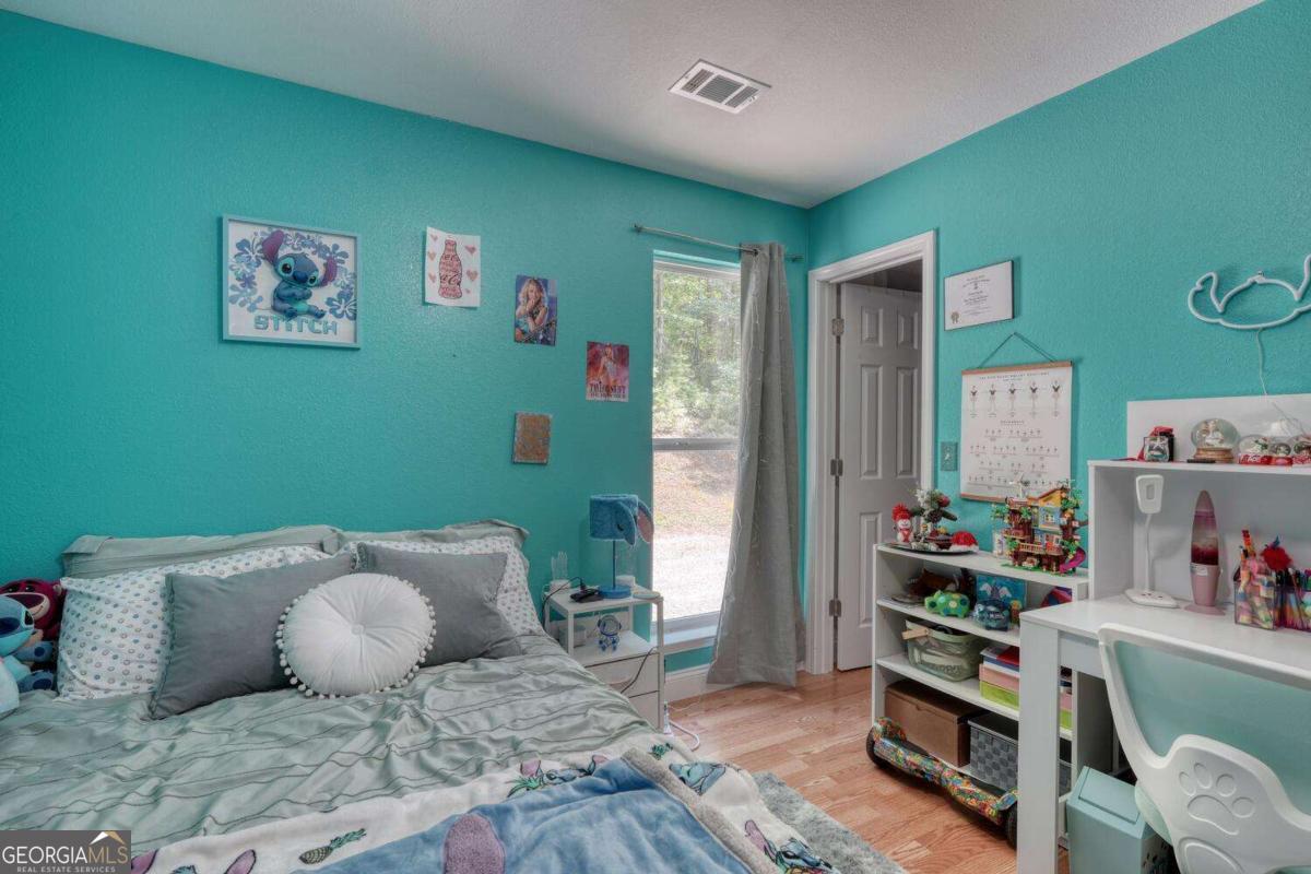 4165 Mobile Road, Unit 4 McCaysville, GA 30555 - Photo 35 of 52 a bedroom with a bed and wooden floor