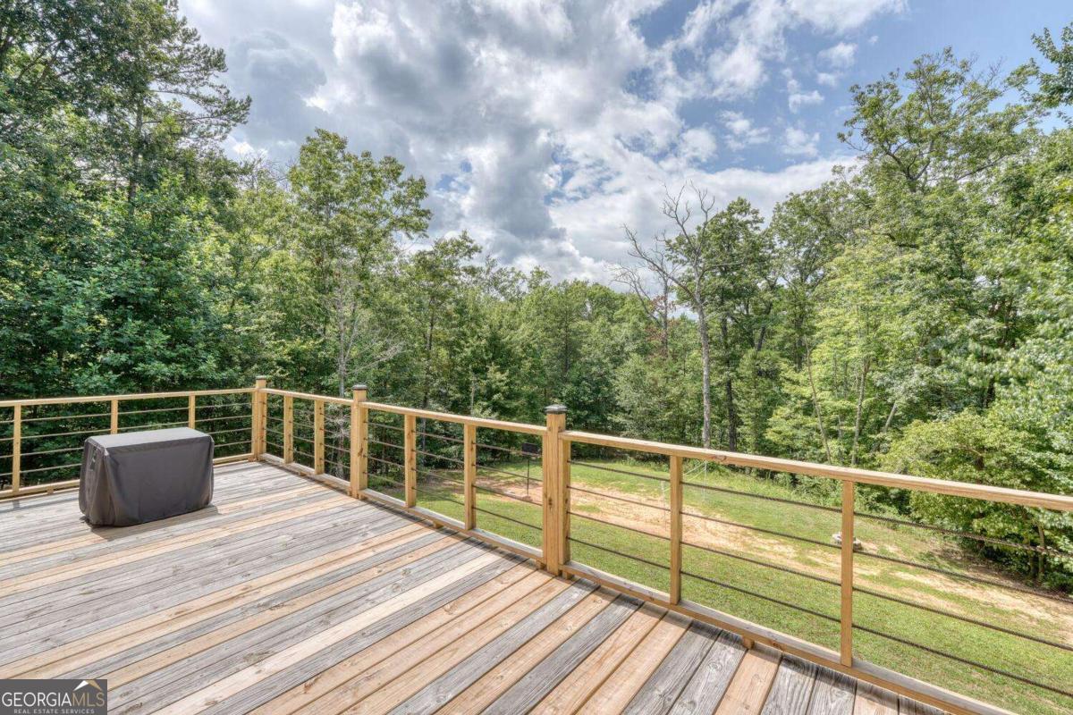 4165 Mobile Road, Unit 4 McCaysville, GA 30555 - Photo 39 of 52 a view of a balcony with wooden floor and fence