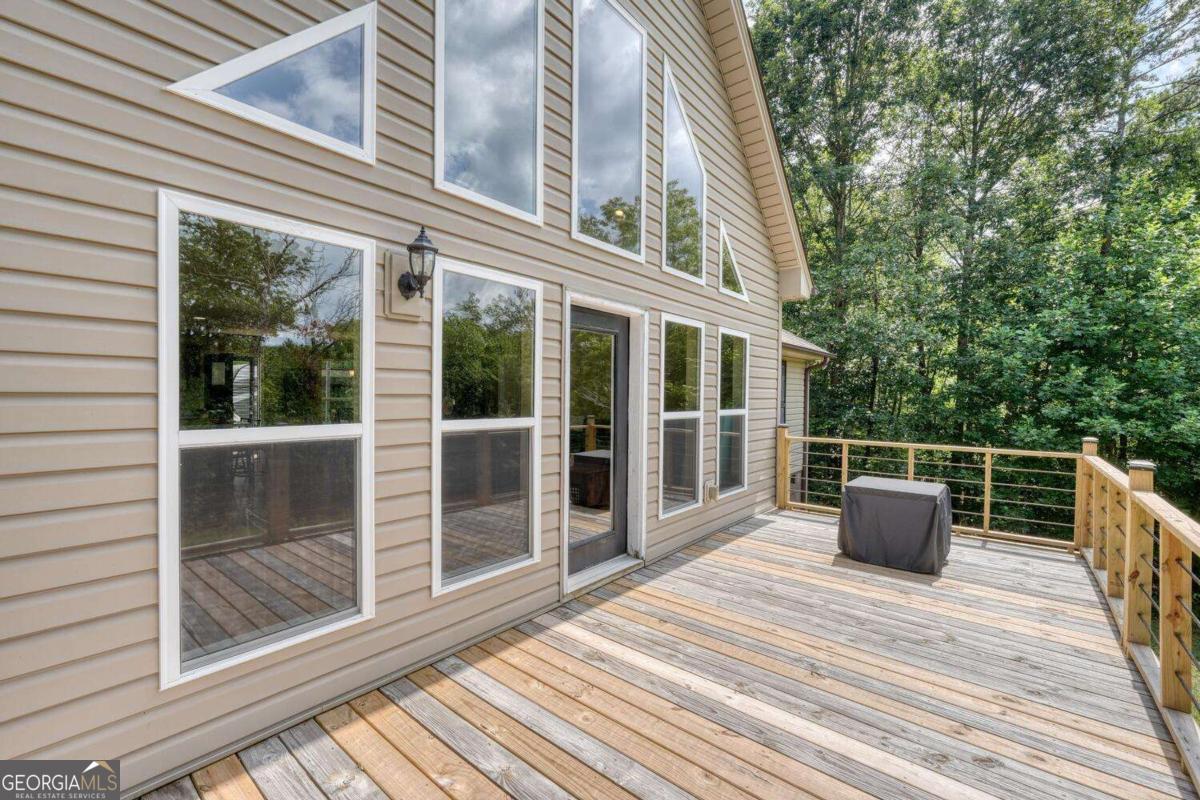 4165 Mobile Road, Unit 4 McCaysville, GA 30555 - Photo 40 of 52 a roof deck with couch and wooden floor
