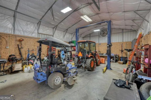an aerial view of a house with a yard and lake view