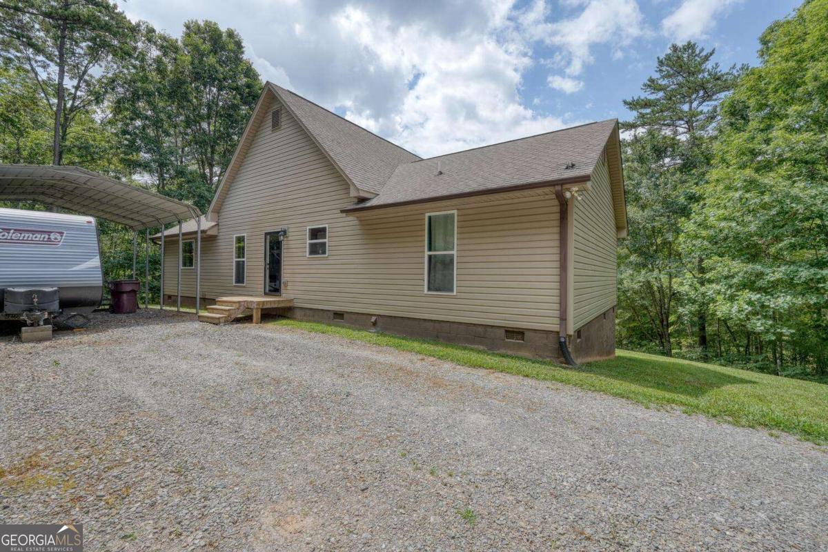 4165 Mobile Road, Unit 4 McCaysville, GA 30555 - Photo 9 of 52 a view of a house with backyard and trees