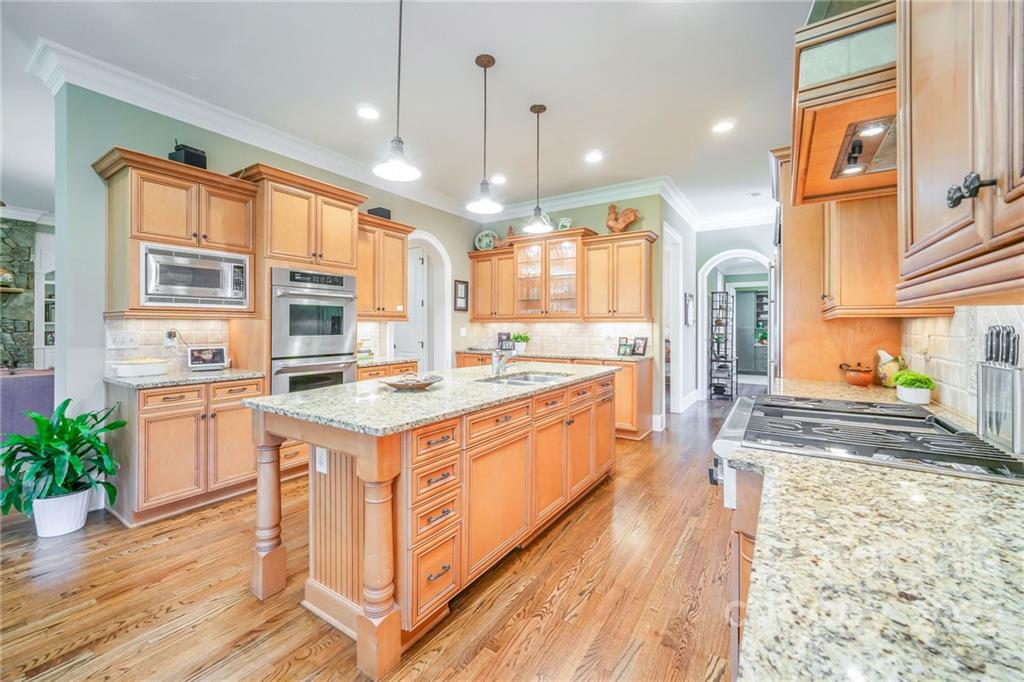 2226 Vernon Drive Charlotte, NC 28211 - Photo 11 of 44 a large kitchen with stainless steel appliances granite countertop a stove and a wooden floors