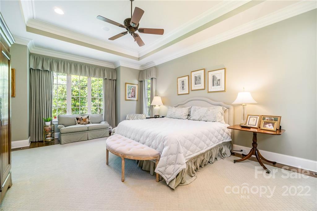 2226 Vernon Drive Charlotte, NC 28211 - Photo 17 of 44 a spacious bedroom with a bed and a chandelier