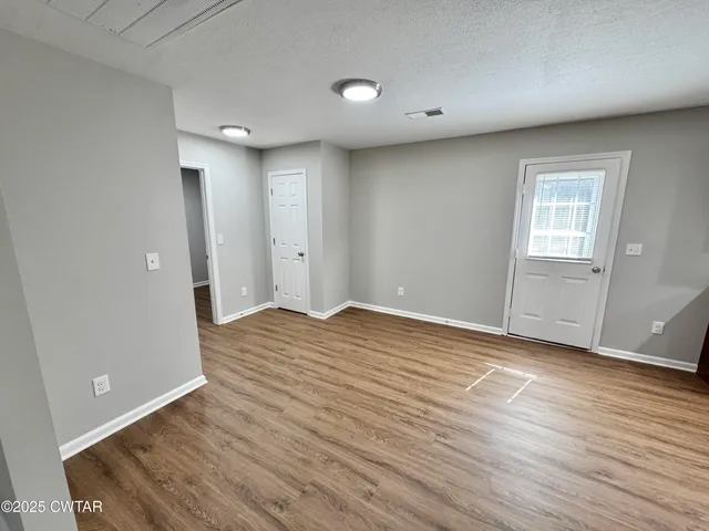 a view of an empty room with a window