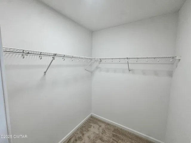 a bathroom with a granite countertop sink toilet a large mirror a vanity and shower