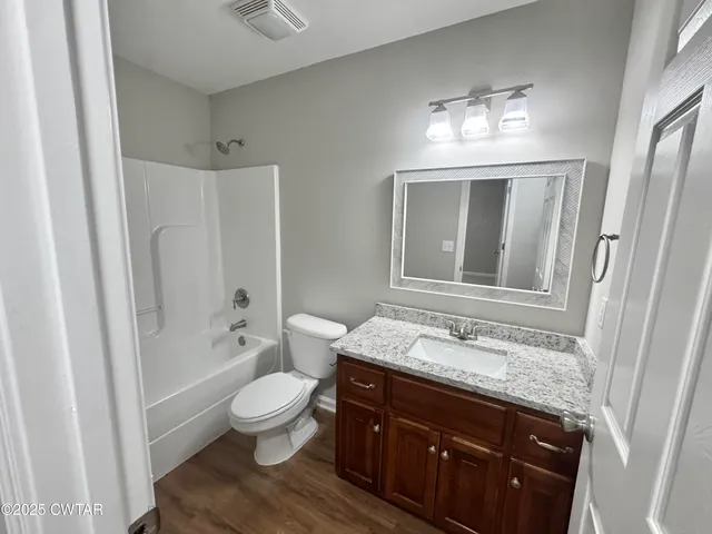 a white toilet sitting next to a bath tub
