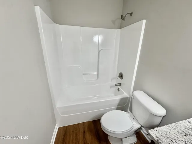 a bathroom with a toilet a sink and a mirror