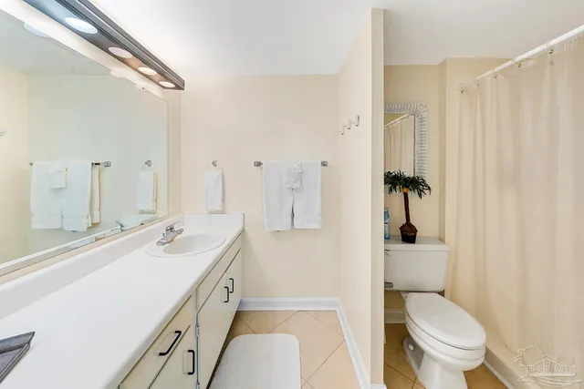 a spacious bathroom with a double vanity sink toilet and shower
