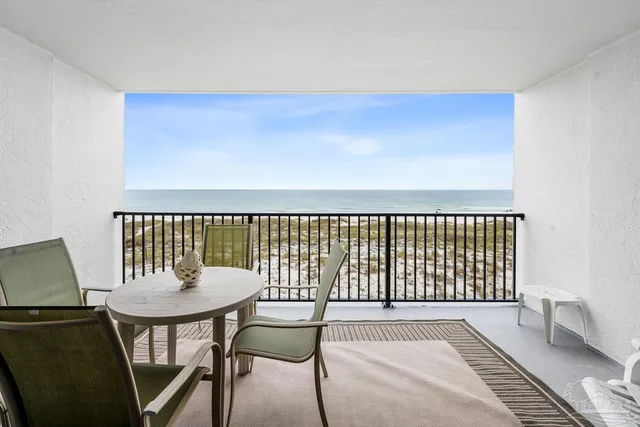 a balcony with table and chairs