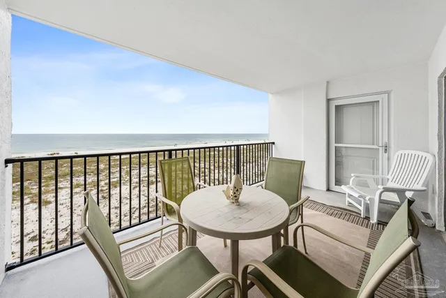 a balcony with table and chairs