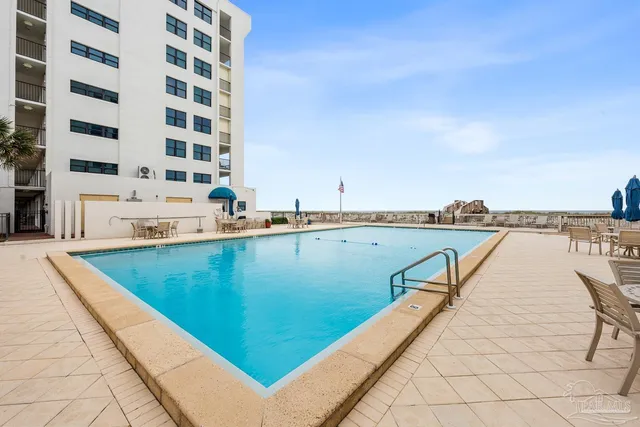 a view of a swimming pool with a lounge chair