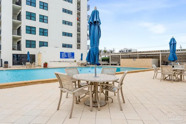 a swimming pool with outdoor seating and yard
