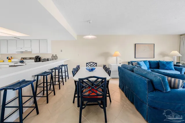 a living room with furniture and painting on the wall