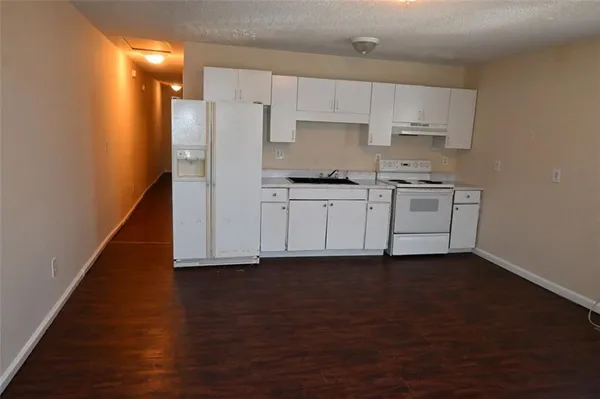 a kitchen with stainless steel appliances a sink and a refrigerator