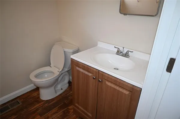 a bathroom with a toilet sink and mirror