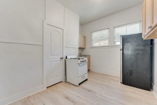 a room with a refrigerator and a stove