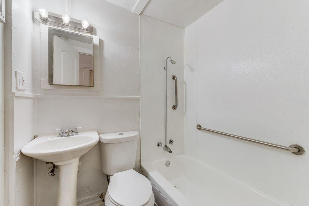 1615 Alston Avenue, Unit C Fort Worth, TX 76104 - Photo 7 of 10 a bathroom with a sink toilet and shower