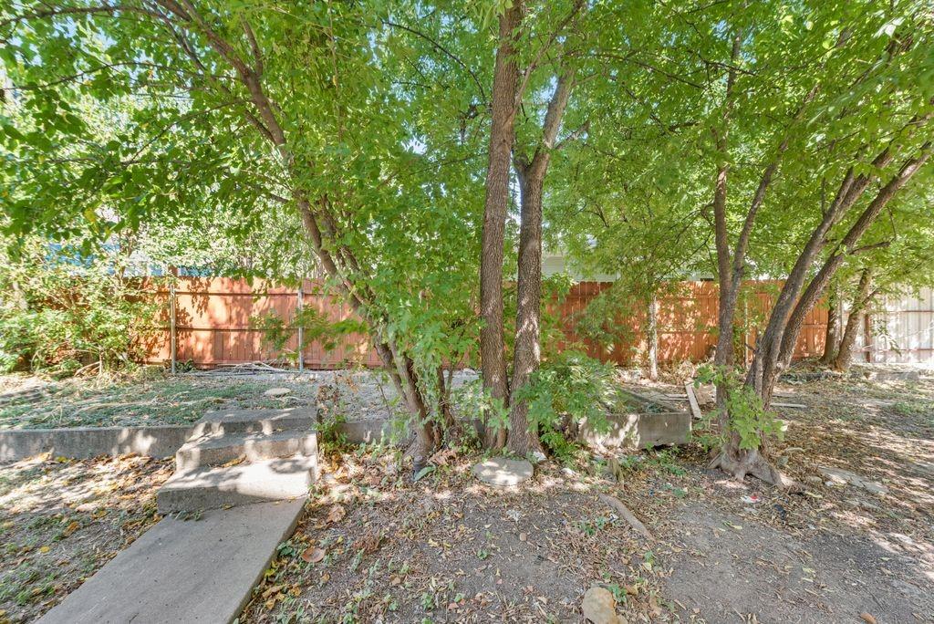 1615 Alston Avenue, Unit C Fort Worth, TX 76104 - Photo 8 of 10 a view of a yard with plants and trees