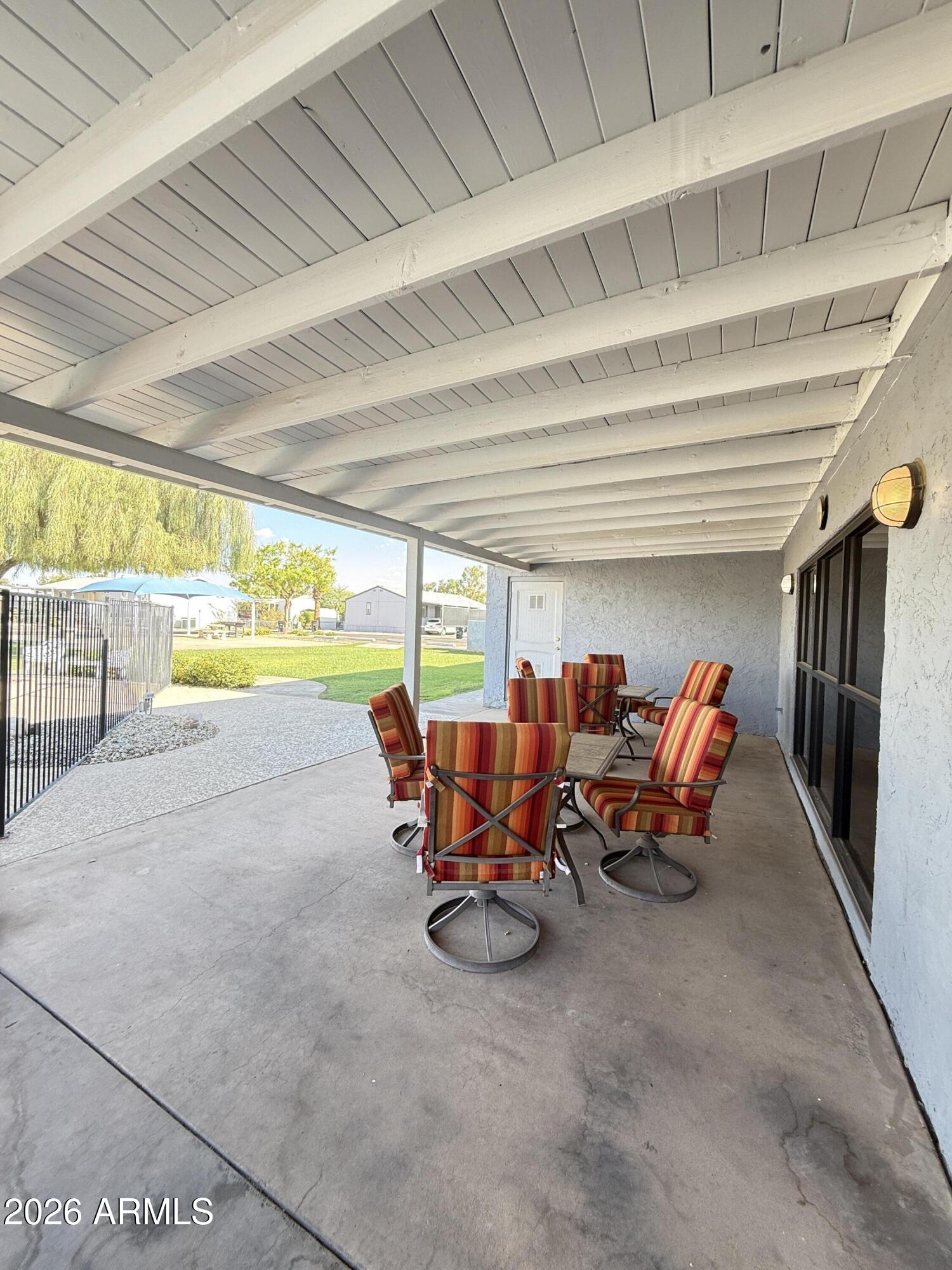 535 South Alma School Road, Unit 113 Mesa, AZ 85210 - Photo 26 of 41 a view of a patio with table and chairs next to an umbrella