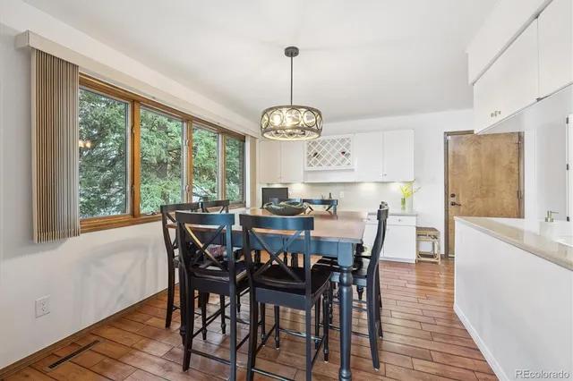 a view of a dining room with furniture window and wooden floor