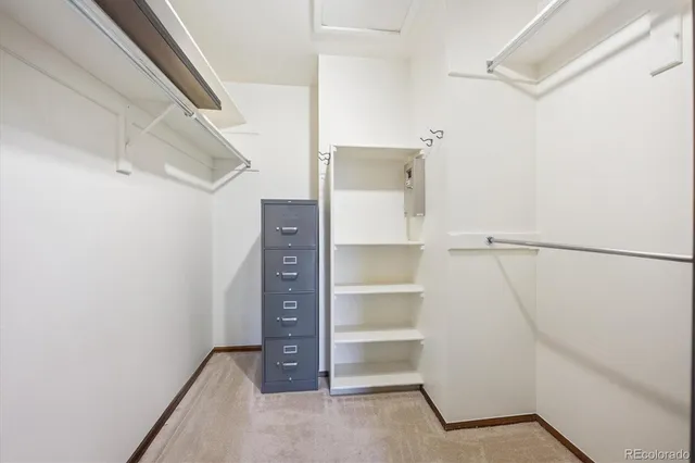 a view of walk in closet with empty racks