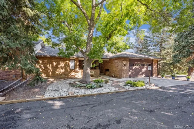 a front view of a house with a yard and shrubs
