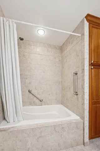 a bathroom with a shower and a bath tub