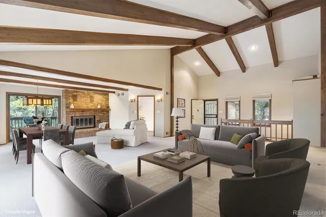 a living room with furniture and large windows