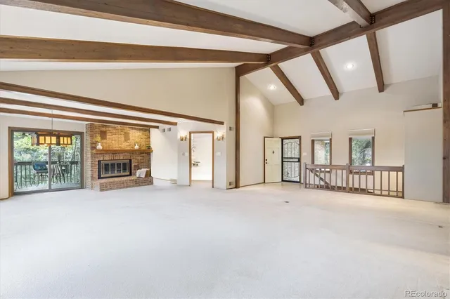 a view of an empty room with large windows