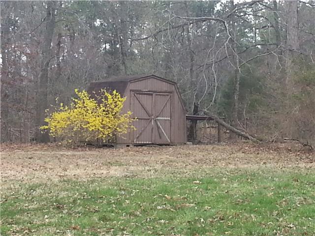 Wooded Backyard with 2 Storage Bldgs!