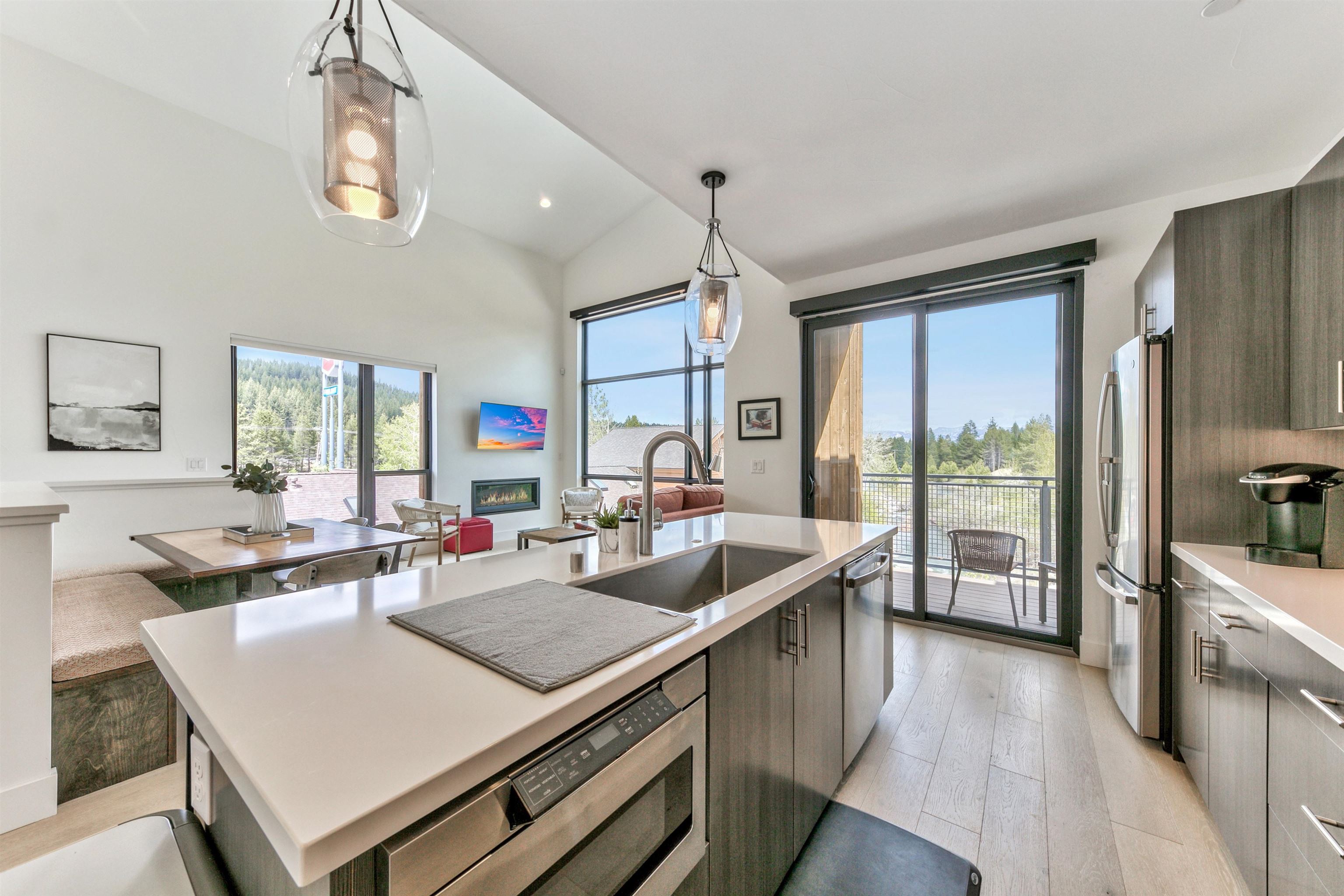 12869 Ice House Loop Truckee, CA 96161 - Photo 16 of 21 a view of a dining room with furniture large windows and wooden floor
