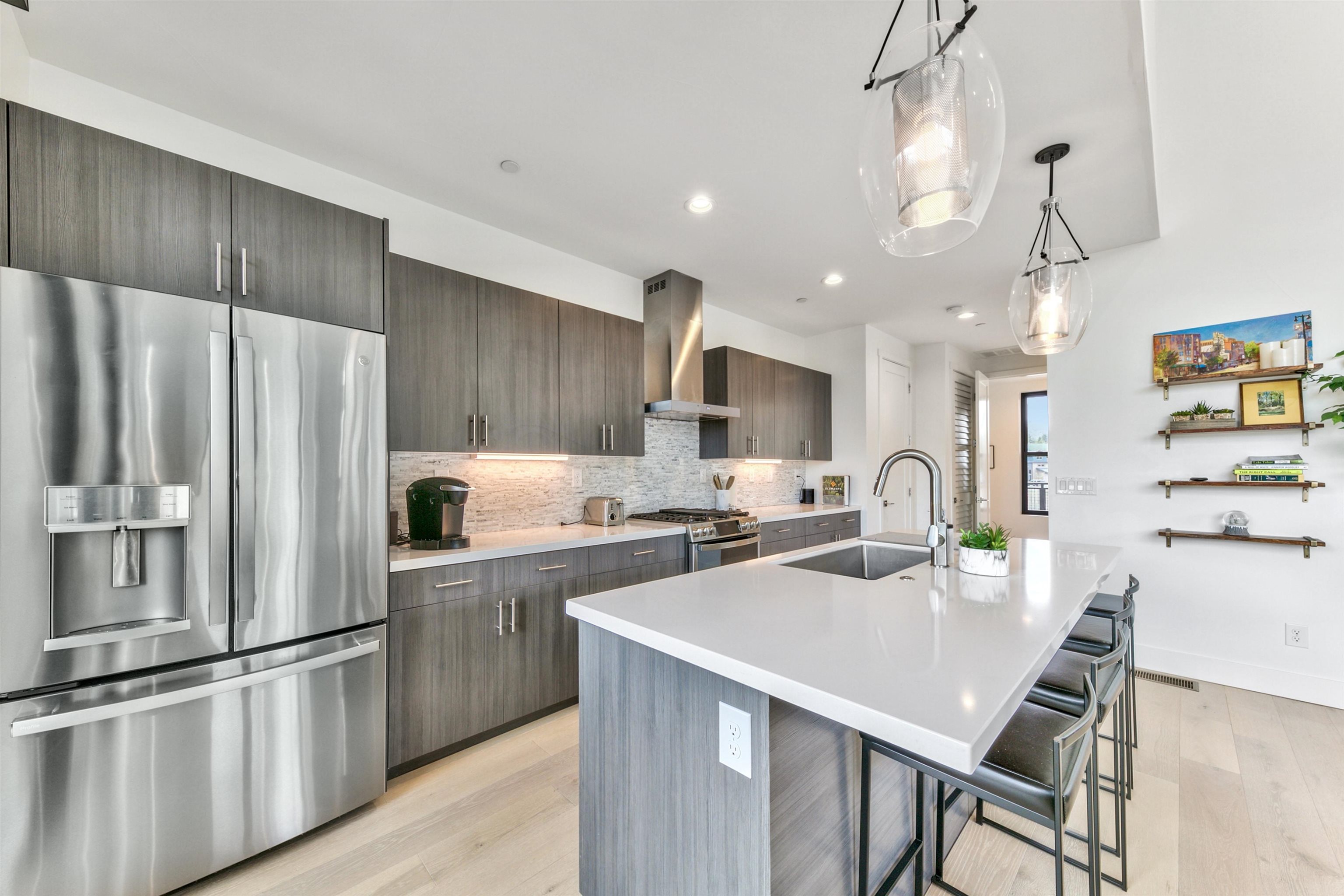 12869 Ice House Loop Truckee, CA 96161 - Photo 17 of 21 a kitchen with stainless steel appliances a refrigerator a stove a sink a dining table and chairs