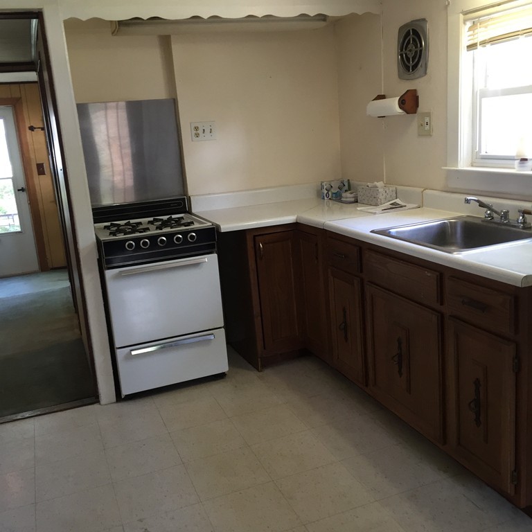 10 Hemlock Road Holbrook, MA 02343 - Photo 6 of 13 a kitchen with a sink stove and cabinets