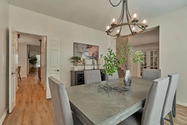 a view of a dining room with furniture and wooden floor