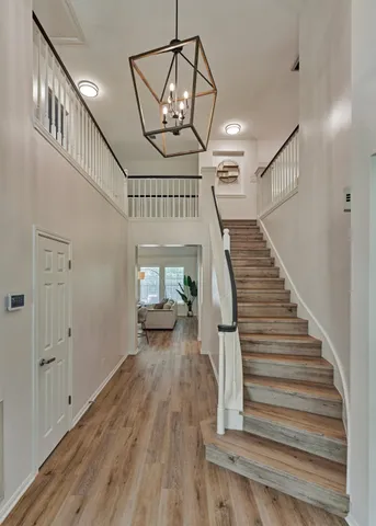 a view of entryway and hall with wooden floor