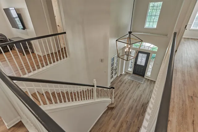 a view of staircase with railing and a floor to ceiling window