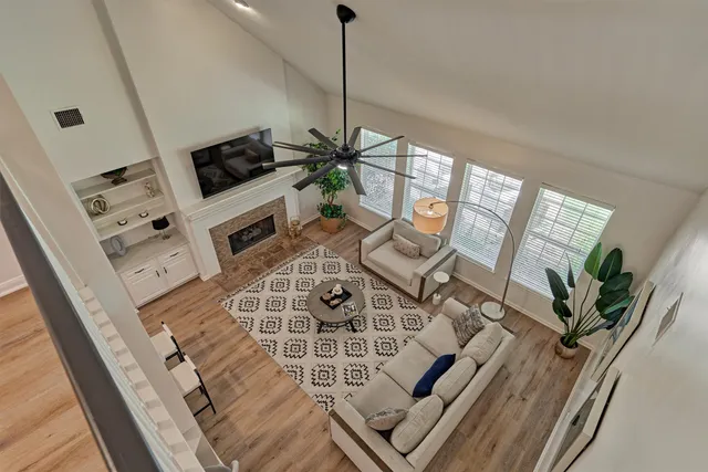 a view of living room with furniture and a fireplace