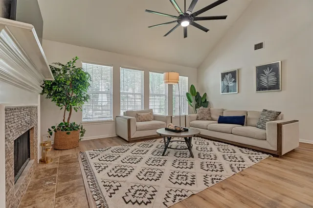 a living room with furniture and a potted plant