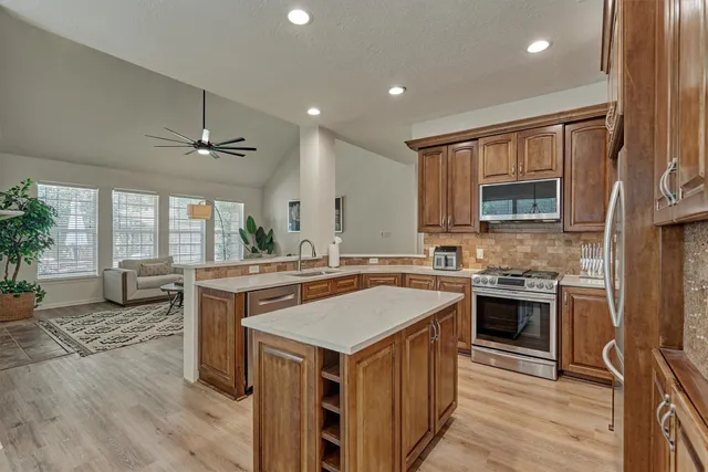 a kitchen with a stove a sink and a refrigerator
