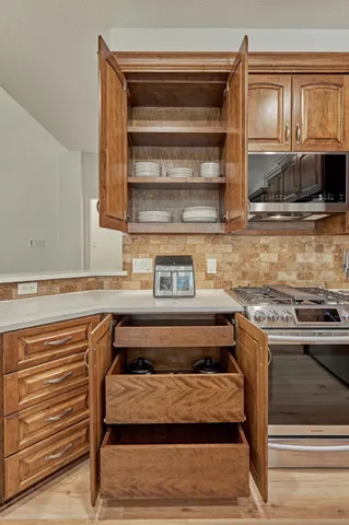 a stove top oven sitting inside of a kitchen
